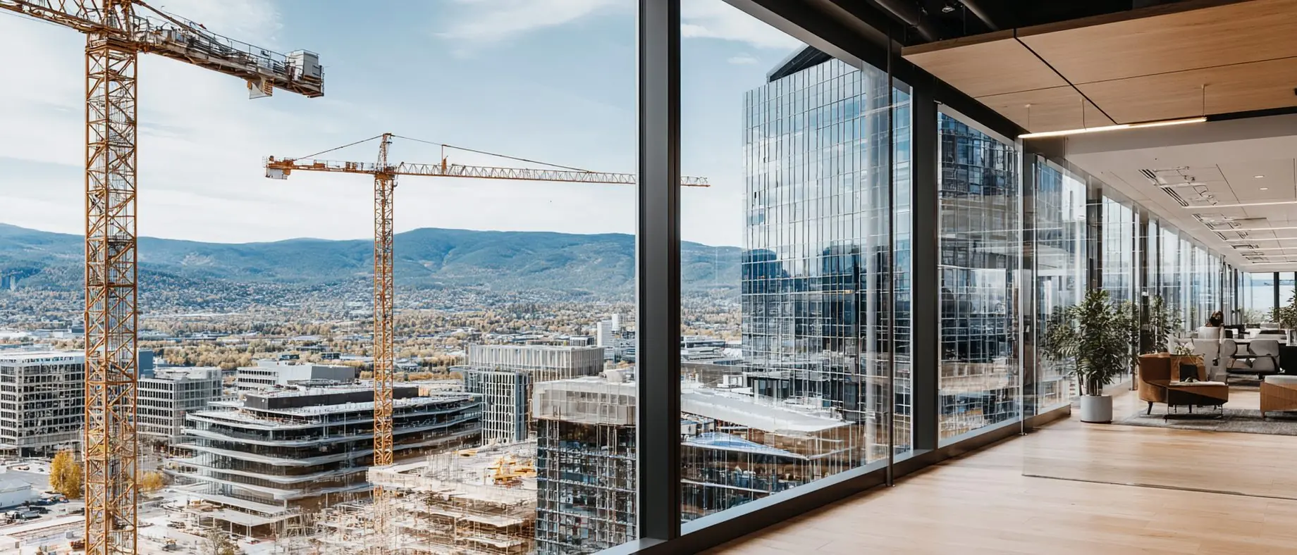 High-floor lounge overlooking a city skyline under construction with tower cranes